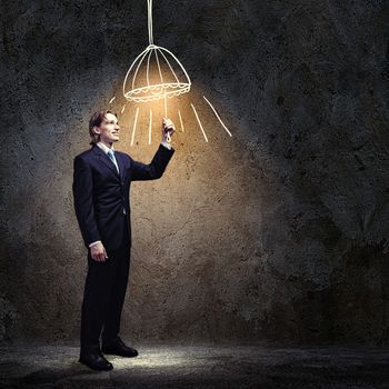 Image of businessman in black suit against dark background