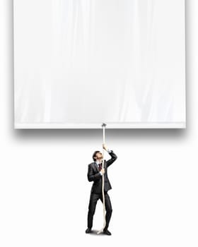 Image of businessman pulling blank banner. Place for text