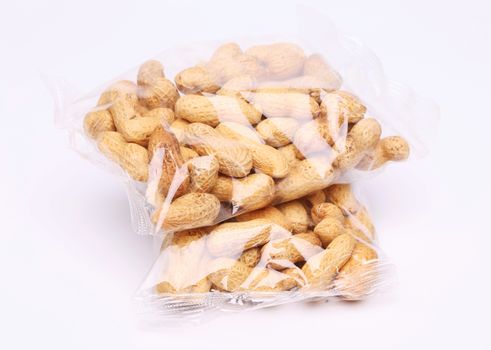 Two plastic bags of peanuts on the white background