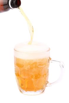 Pouring beer into mug isolated over a white background