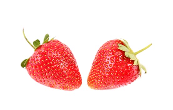 two fresh red strawberries with leaves on a white background