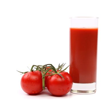 Tomato juice in glass with a cluster of small tomatoes isolated on white background