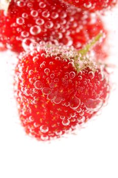 Sparkling wine (champagne) and strawberry on a white background