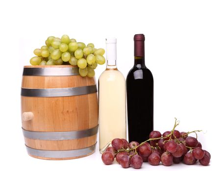 barrel and bottles of wine and ripe grapes on barrel