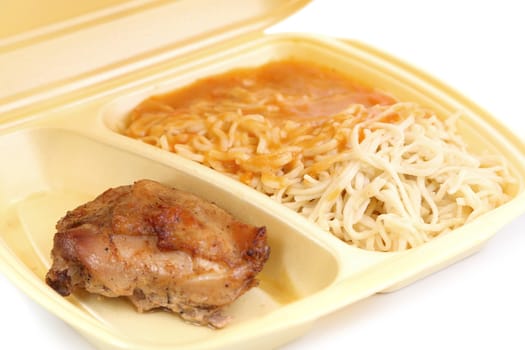 Chicken with pasta in food container on a white background