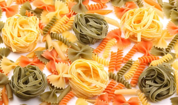 A different pasta in three colors on the white background.