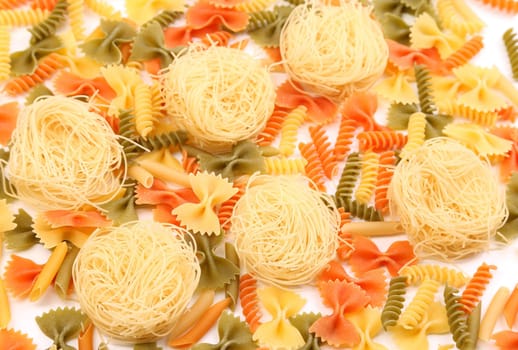 A different pasta in three colors close-up on the white background.