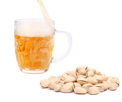 Glass of beer and pistachios on a white background