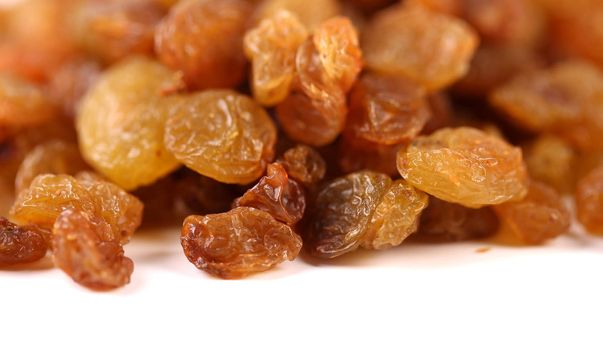 Golden raisins are located on top background