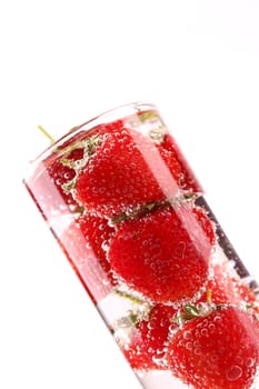 Strawberries and bubbles into glass on a white background