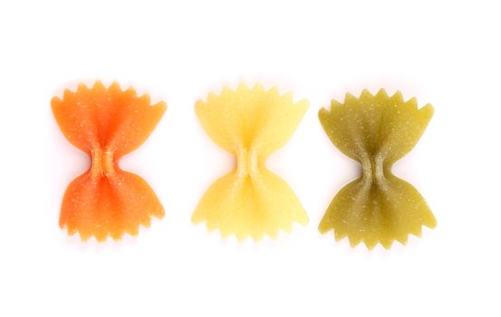 Farfalle pasta, isolated, three colors on a white background.