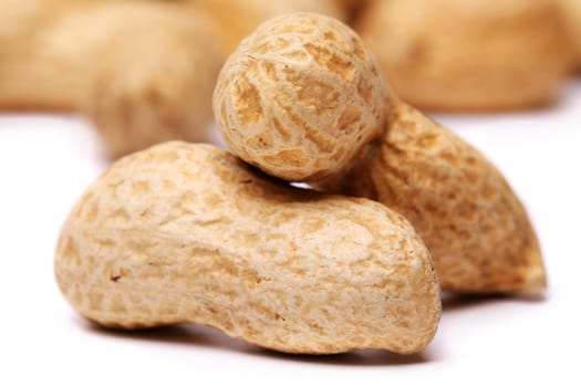 close-up of some peanuts on a background of other peanuts