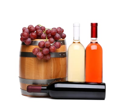barrel, bottles of wine and ripe grapes on barrel