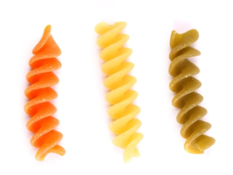 Close-up pasta eliche tricolori are located on the white background.