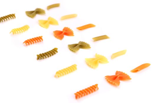 crossover from different color pasta on a white backgroun