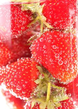 Sparkling wine (champagne) and strawberry on a white background