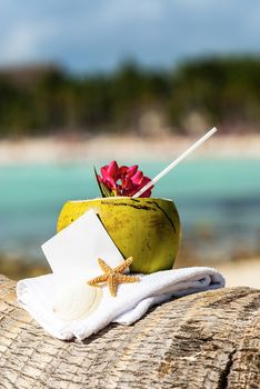 Coconut cocktail starfish tropical Caribbean beach refreshment and towel