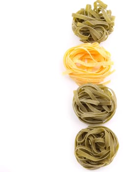 Tagliatelle paglia e fieno tipycal italian pasta close-up on the white background.