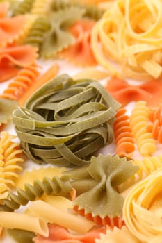 Different pasta in three colors. Close-up. Background.