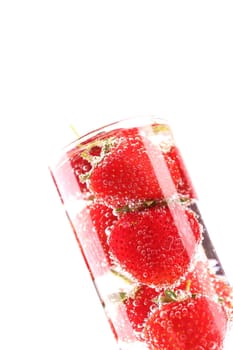 Strawberries and bubbles into glass on a white background.