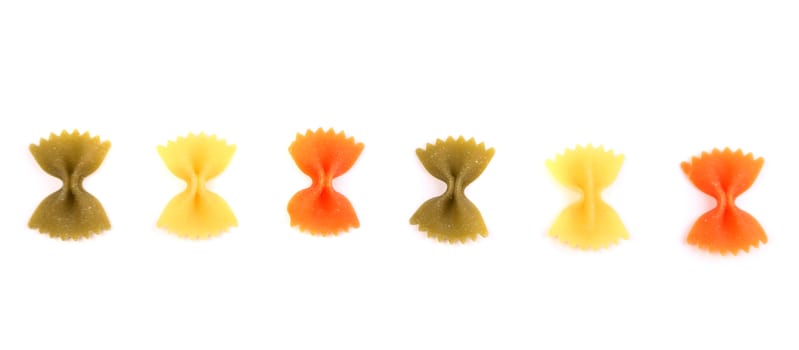 Pasta farfalle three colors are located on the white background.