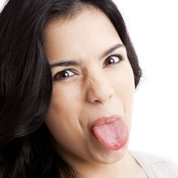 Portrait of a  young woman with her tongue out, isolated over white background