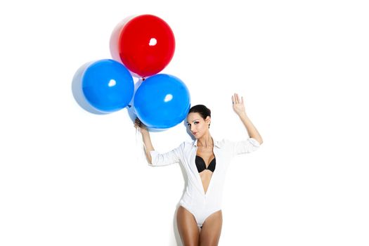 Fashion portrait of a beautiful young women posing with ballons, isolated on white