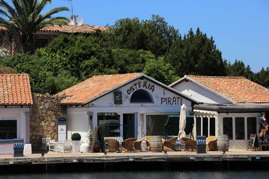 PORTO CERVO, ITALY - JUNE 18: Promenade, waterfront and pier of a luxury resort in the north of Sardinia, designed by the architect Luigi Vetti as the center of the Emerald Coast  on  June 18, 2013 in Porto Cervo, Italy
