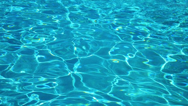 Liquid surface of summer swiming pool in blue color