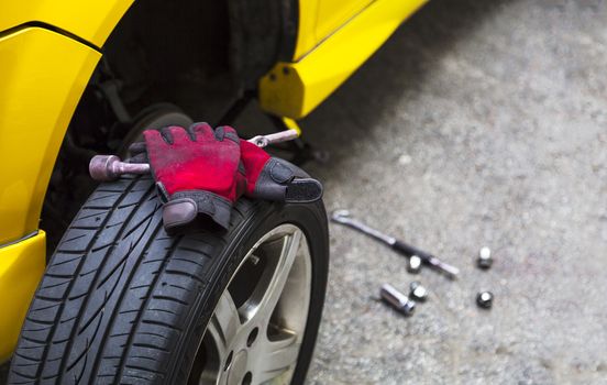 Close up of a breakdown car in the process of repairing. With copy space on the right.