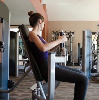 Girl training in gym on sport machine