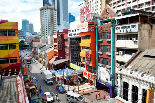 Kuala Lumpur, Malaysia -  May 11, 2013: People walking on Chinatown street in Kuala Lumpur. KL is the capital and most populous city in Malaysia. Covers an area of 243 km2 and has population of 1.6 million in 2012