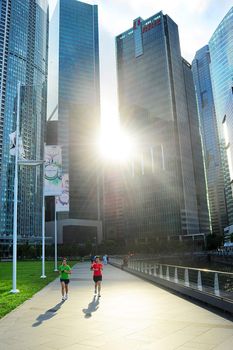 Singapore, Republic of Singapore - March 06, 2013: Unidentified people runnig in front of Singapore downtown. Singapore has been recognized as one of the best cities for runners in Asia.