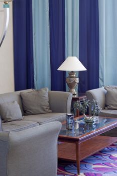 Detail of a living room with lamp sofa and table