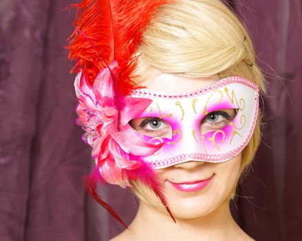 An attractive woman poses with her venetian mask.