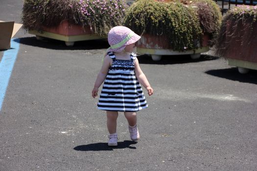 Little cute blond girl (one year and seven months of age) at the port in Porto Cervo. Sardinia