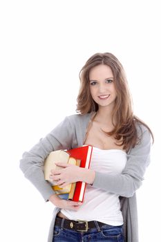 Attractive young female student in casual clothes smiling and carrying her books under her arm isolated on white