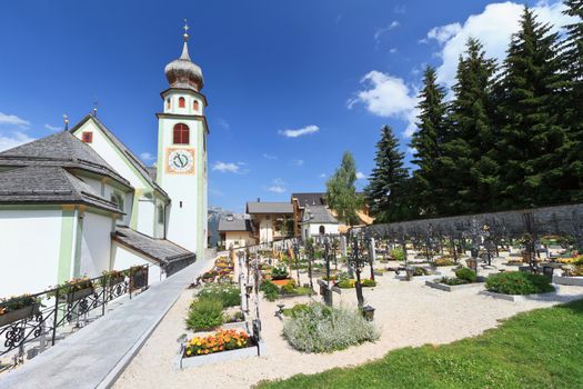 church with graveyard in San Cassiano, Val Badia, Italy