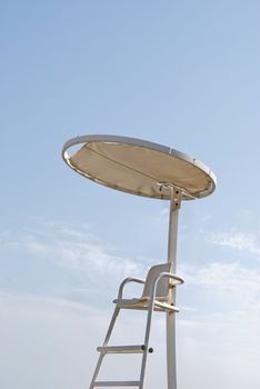 Lifeguard post on blue sky background