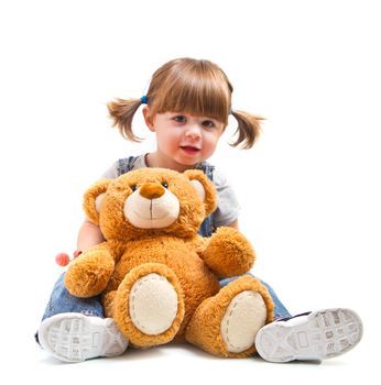 adorable toddler girl hugging a teddy bear