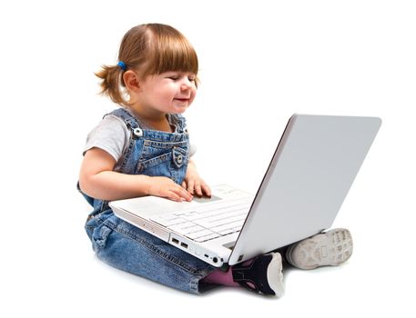 Cute little girl sitting with a laptop 