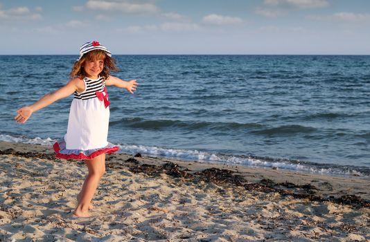 beautiful happy little girl on beach