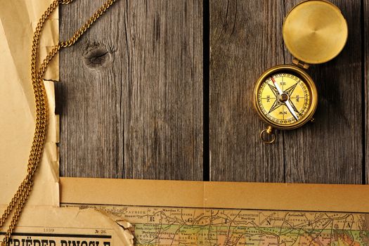 Antique brass compass over old map