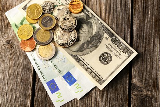 US and euro currency over wooden background