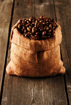 Coffee beans in bag on wooden table