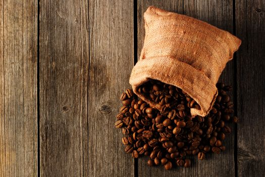 Coffee beans in bag on wooden table