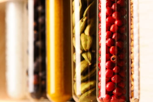 Spices in beakers against dark background