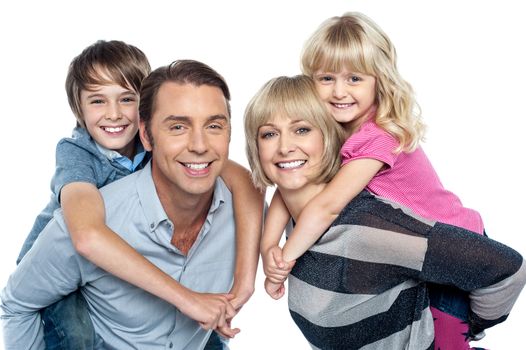 Portrait of friendly family of four in the studio