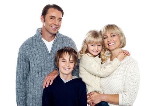 Smiling family of four posing in trendy winter wear