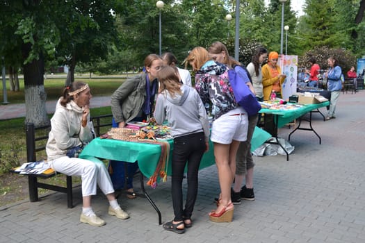 Girls examine goods on a street counter